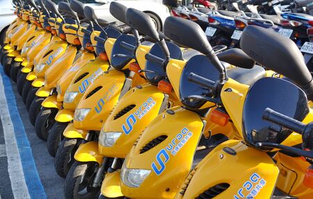 KAOHSIUNG, TAIWAN -- DECEMBER 14, 2019: A row of electric scooters that are available for rent.のeditorial素材