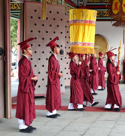 KAOHSIUNG, TAIWAN -- SEPTEMBER 28 , 2017: Ceremonial attendants in red robes take up positions for...