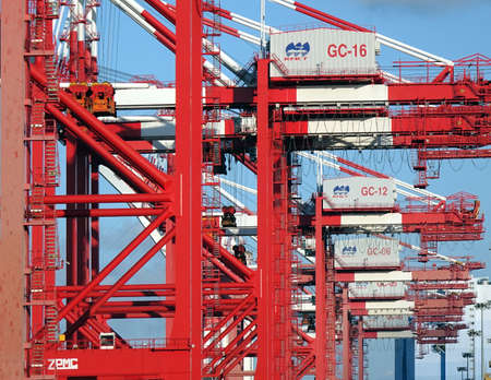 KAOHSIUNG, TAIWAN -- JUNE 2, 2019: A row of red and white container cranes in Kaohsiung Port.のeditorial素材
