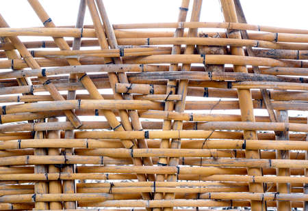 A traditional handmade bamboo fence made from slats and stripsの写真素材