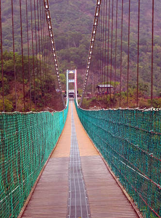 A traditional suspension bridge in the Maolin Scenic Areaの写真素材