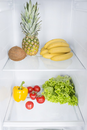Open fridge full of fresh fruits and vegetables, healthy food background, organic nutrition, health care, dieting conceptの写真素材