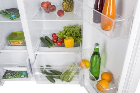 Open fridge full of fresh fruits and vegetables, healthy food background, organic nutrition, health care, dieting conceptの写真素材