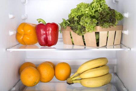 Open fridge full of fresh fruits and vegetables, healthy food background, organic nutrition, health care, dieting conceptの写真素材