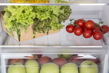 Open fridge full of fresh fruits and vegetables, healthy food background, organic nutrition, health care, dieting conceptの写真素材