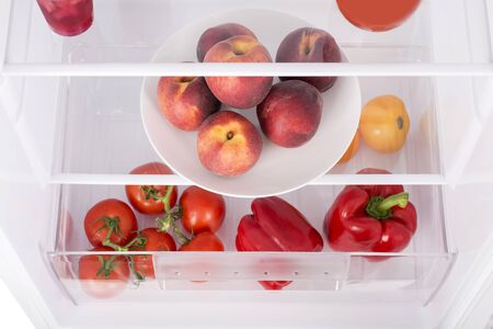 Open fridge full of fresh fruits and vegetables, healthy food background, organic nutrition, health care, dieting conceptの写真素材