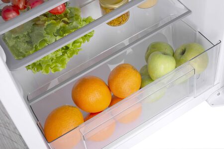 Open fridge full of fresh fruits and vegetables, healthy food background, organic nutrition, health care, dieting conceptの写真素材