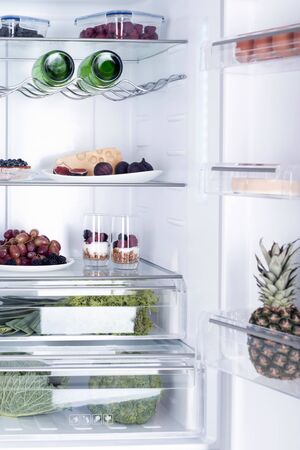 Open fridge full of fresh fruits and vegetables, healthy food background, organic nutrition, health care, dieting conceptの写真素材
