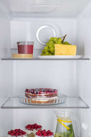 Open fridge full of fresh fruits and vegetables, healthy food background, organic nutrition, health care, dieting conceptの写真素材