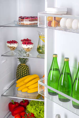 Open fridge full of fresh fruits and vegetables, healthy food background, organic nutrition, health care, dieting conceptの写真素材