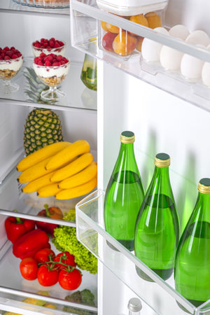 Open fridge full of fresh fruits and vegetables, healthy food background, organic nutrition, health care, dieting conceptの写真素材