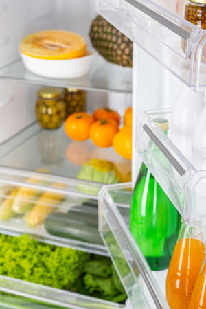 Open fridge full of fresh fruits and vegetables, healthy food background, organic nutrition, health care, dieting conceptの写真素材