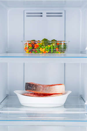 Open fridge full of fresh fruits and vegetables, healthy food background, organic nutrition, health care, dieting conceptの写真素材