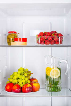 Open fridge full of fresh fruits and vegetables, healthy food background, organic nutrition, health care, dieting conceptの写真素材