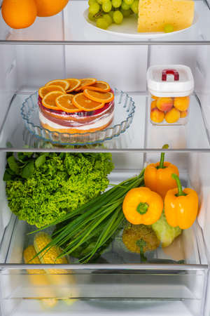 Open fridge full of fresh fruits and vegetables, healthy food background, organic nutrition, health care, dieting conceptの写真素材