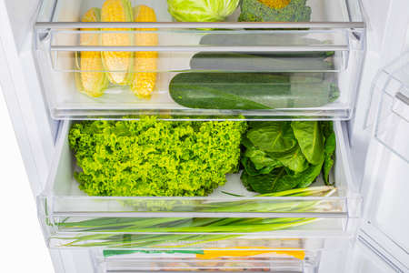 Open fridge full of fresh fruits and vegetables, healthy food background, organic nutrition, health care, dieting conceptの写真素材