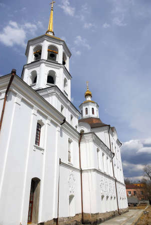 White orthodox church with glden domes. Captured with wide-angle. Deep blue cloudy skyの写真素材