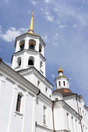 The side wall and towers of white orthodox cathedral. Deep blur cloudy sky.の写真素材