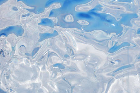 Background of bizarred transparent surface of ice. Shapeless optical distortion effectsの写真素材