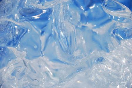 Background of bizarre transparent surface of ice. Shapeless optical distortion and refraction effectsの写真素材