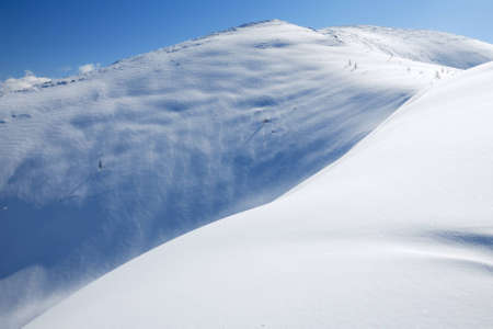 The snow slope in winter mountains. Freeride and backcountry snowboarding/skiing place