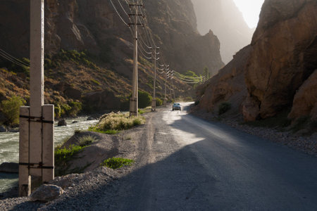 Car on the bumpy road in mountain canyon in evening lightの写真素材