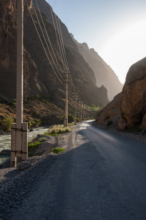 Old bumpy road in mountain canyon in evening lightの写真素材