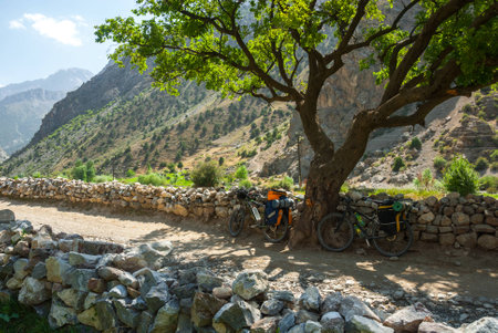 Two touring bicycles on the country road in mountain villageの写真素材
