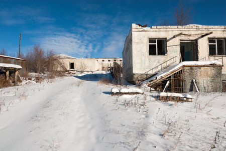 Abandoned prison settlement with decayed buildings in Northern Kolyma winter viewの写真素材