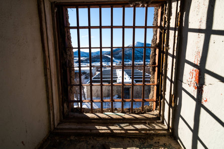 View through latticed window of abandoned prison in Kolymaの写真素材