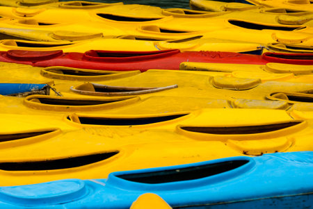 Many yellow, red and blue ocean kayaks on the pier. Abstract  backgroundの写真素材