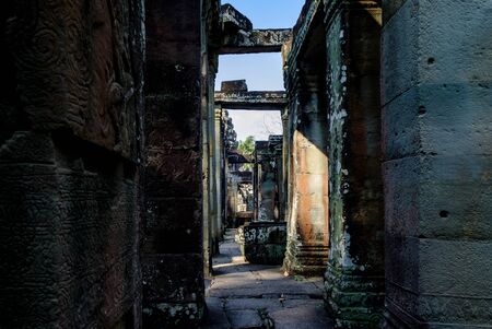 Narrow corridors in ruins of old ancient Angkor temple in Cambodia. Abstract architectural background.の写真素材