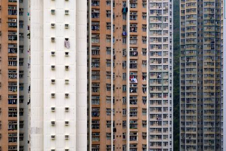 Brown and gray all of multistoried apartment building with many same windows and balconies. Abstract city background.の写真素材