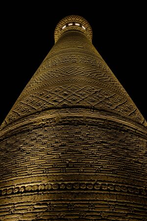 Kalyan minaret in Bukhara. Old ancient minaret in electric lights. Night view.の写真素材