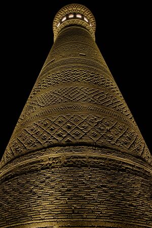 Kalyan minaret in Bukhara. Old ancient minaret in electric lights. Night view.の写真素材