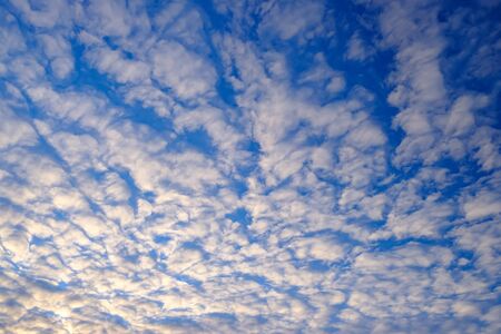 Cloudy morning sky with yellowish sunlight. Abstract natural background.の写真素材
