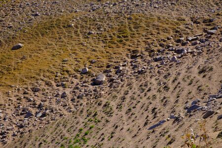 Sandy mountain slope with rocks. Abstract natural background.の写真素材