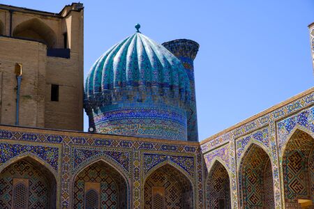 Exterior of old ancient moslem madrassah with big cupola and tiled walls in Samarkand, Uzbekistan. Central Asia travel viewの写真素材