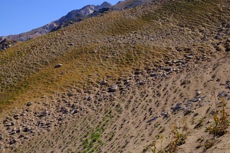 Sandy mountain slope with rocks. Abstract natural background.の写真素材