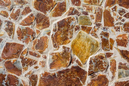 wall background of yellow and red stoneの写真素材
