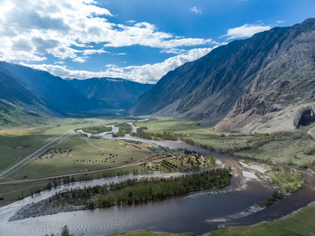 Summer landscape in the Chulyshman mountain valley. Winding mountain river, green alpine meadows and beautiful mountains.の写真素材