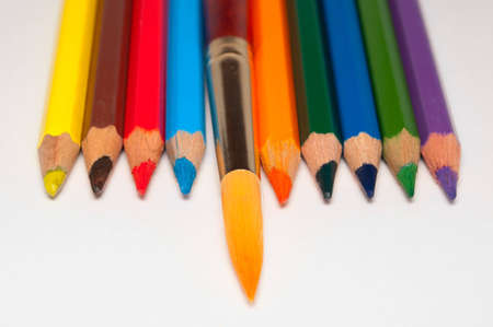 Color pencils and paintbrush on a white backgroundの写真素材