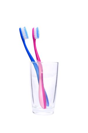 isolated blue and pink toothbrushes in the glassの写真素材