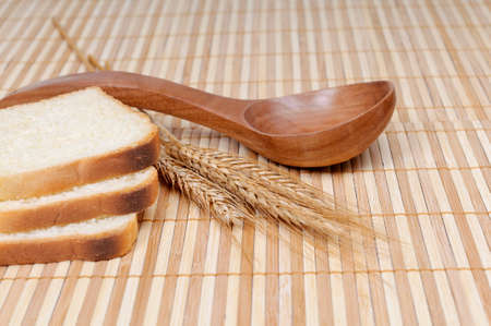 slices of bread with a spoon and cerealsの写真素材