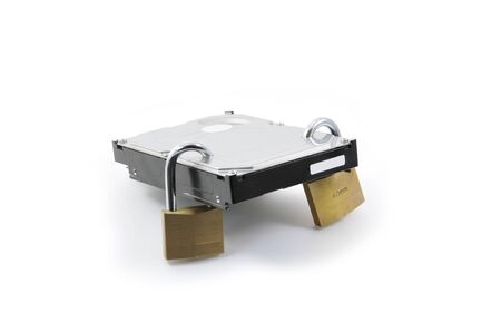 Hard disk back view with two locked padlocks on a white backgroundの写真素材