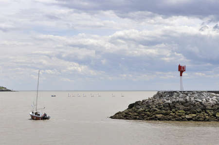 Line of School Boats Near the Coast with a Cloudy Skyの写真素材