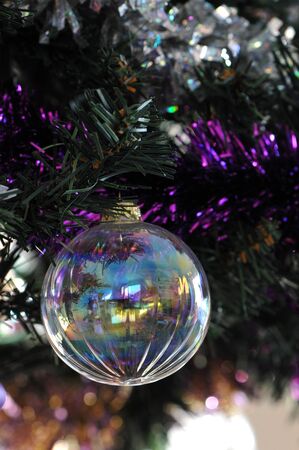 Transparent Christmas Ball in an artificial Pineの写真素材