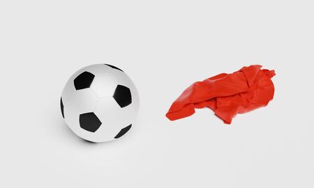 Football with a Red Fabric piece to the right with a white backgroundの写真素材