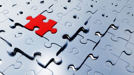 Many silver puzzle pieces almost in place with one large red piece between them with a white backgroundの写真素材