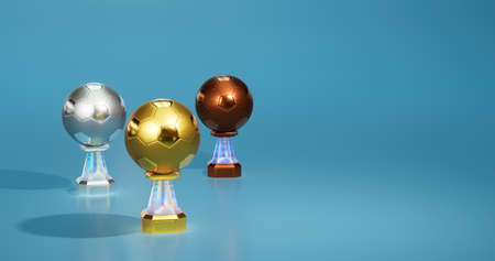 Bright Football Gold Silver and Bronze Trophies with a soft light blue backgroundの写真素材